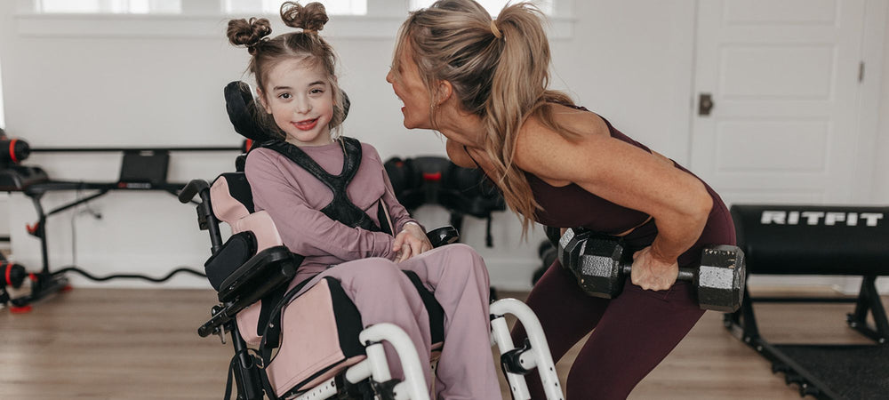 Shannon Willardson working out fitness with child in home gym all that nutrition