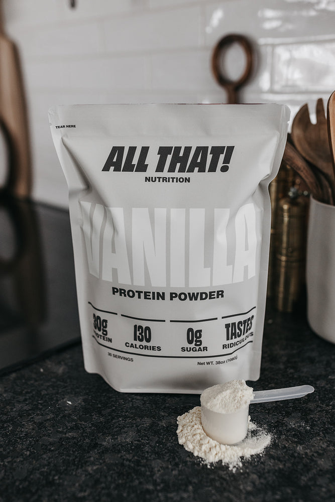 a bag of vaniila protein powder on the counter with a scoop sitting next to it