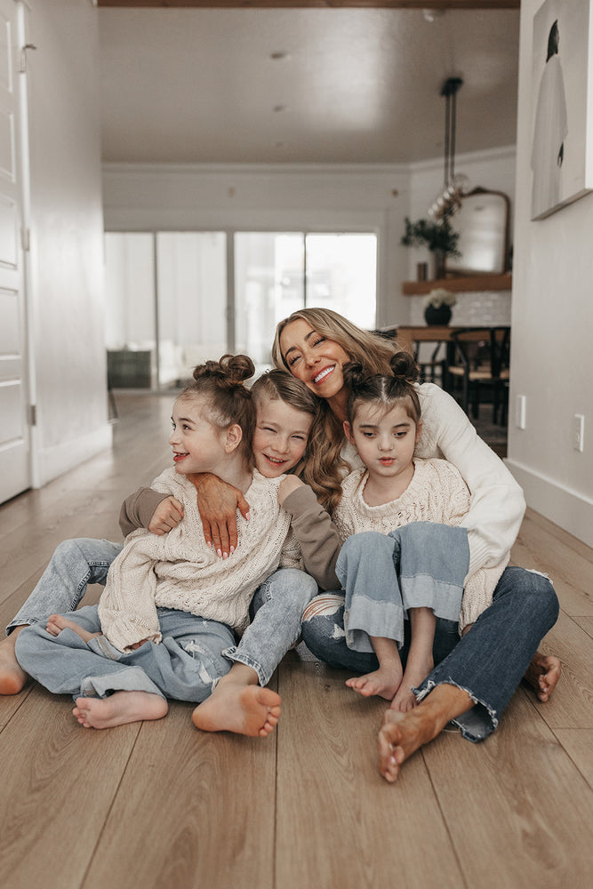 Shannon sitting on the floor with her three kids