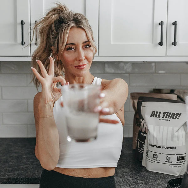 Woman holding glass with protein shake